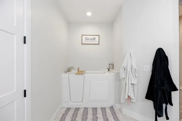 Bathroom featuring a bath and recessed lighting