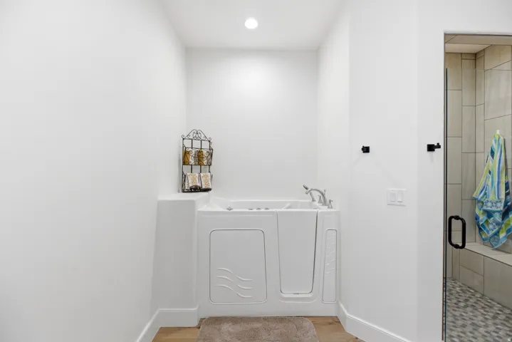Laundry room with recessed lighting and light wood-type flooring