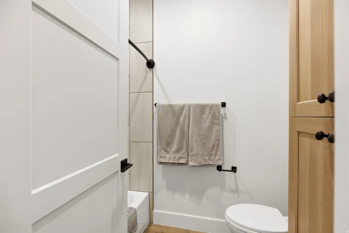 Bathroom featuring toilet and bathing tub / shower combination