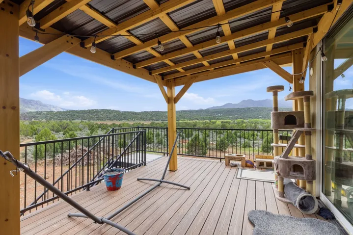 Wooden deck with a mountain view and a view of trees