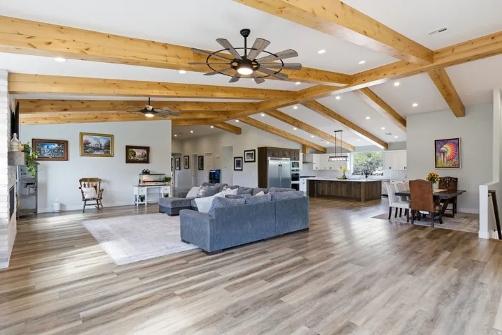 Living room with recessed lighting, light wood-style flooring, and ceiling fan