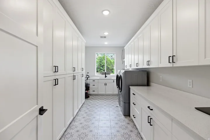 Laundry room with cabinet space, independent washer and dryer, recessed lighting, and light flooring