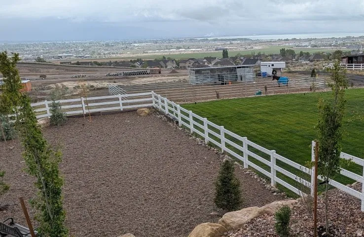 Fenced backyard with a rural view