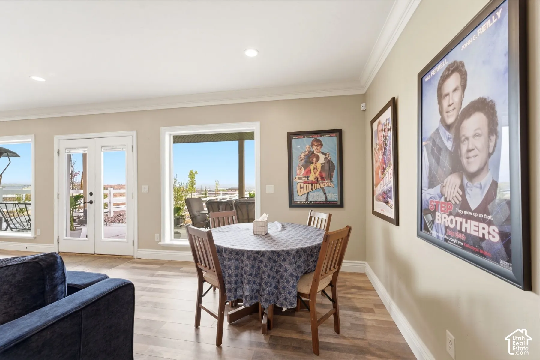 Dining room with french doors, crown molding, light wood-type flooring, and recessed lighting