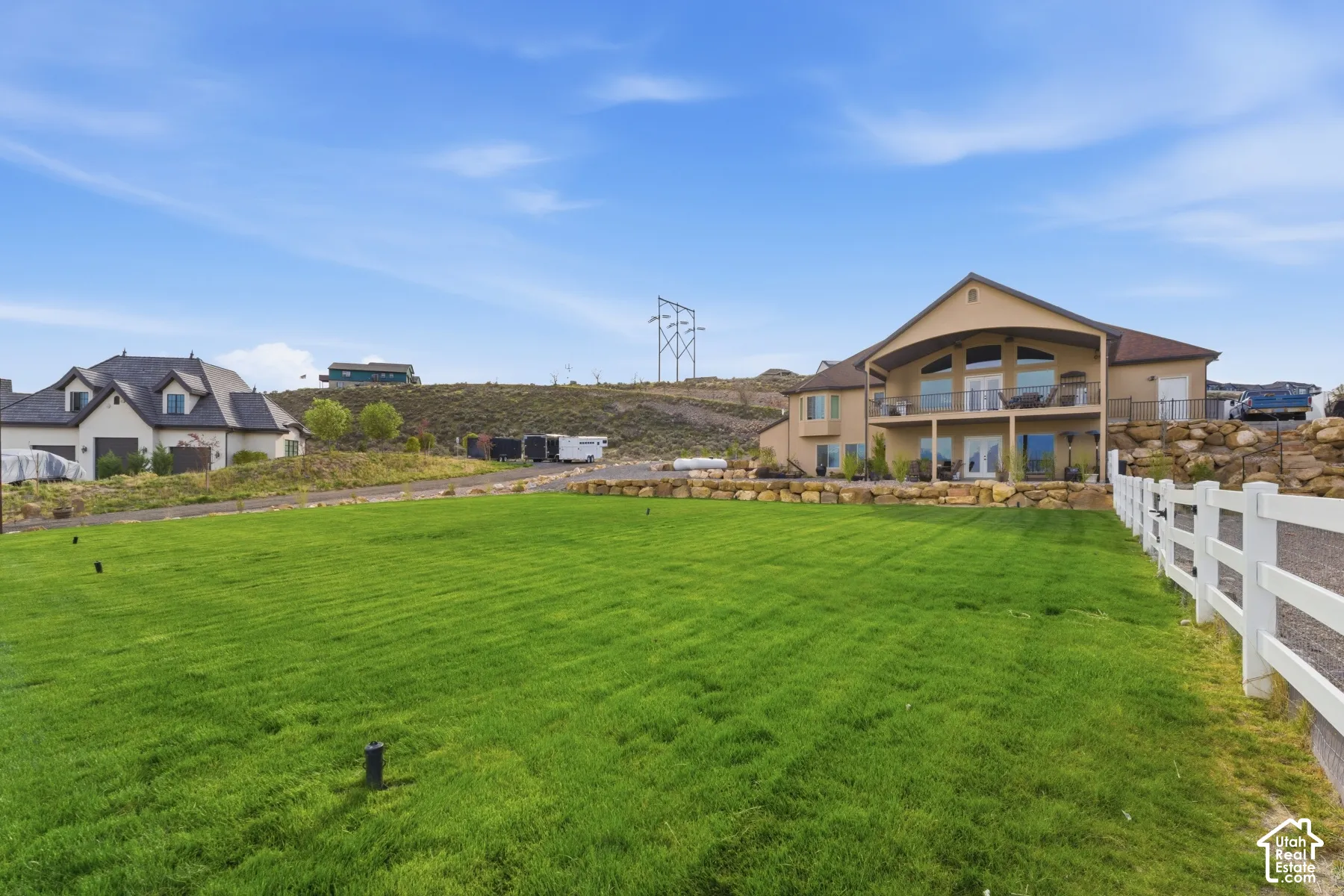 View of grassy yard with a balcony