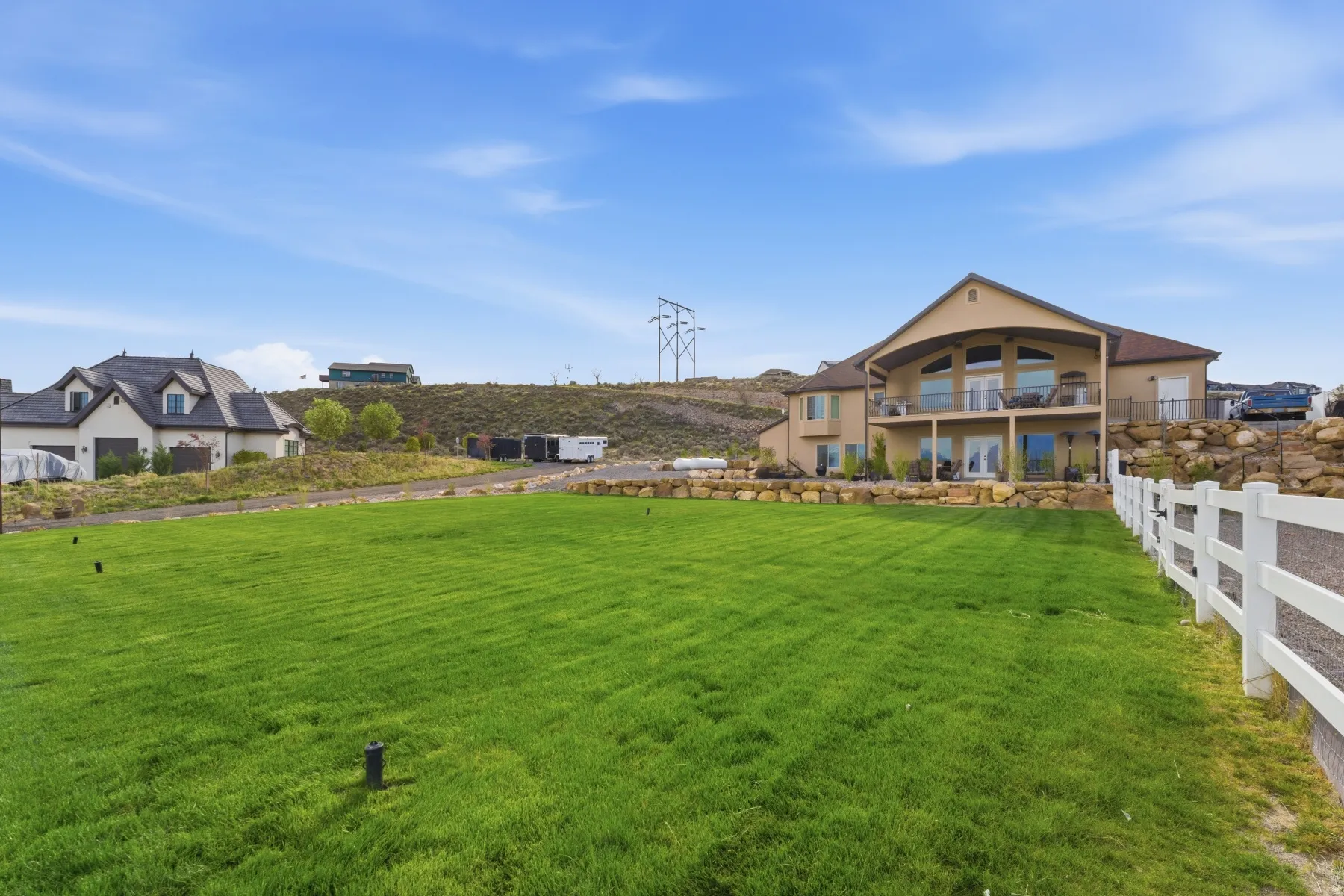 View of grassy yard with a balcony