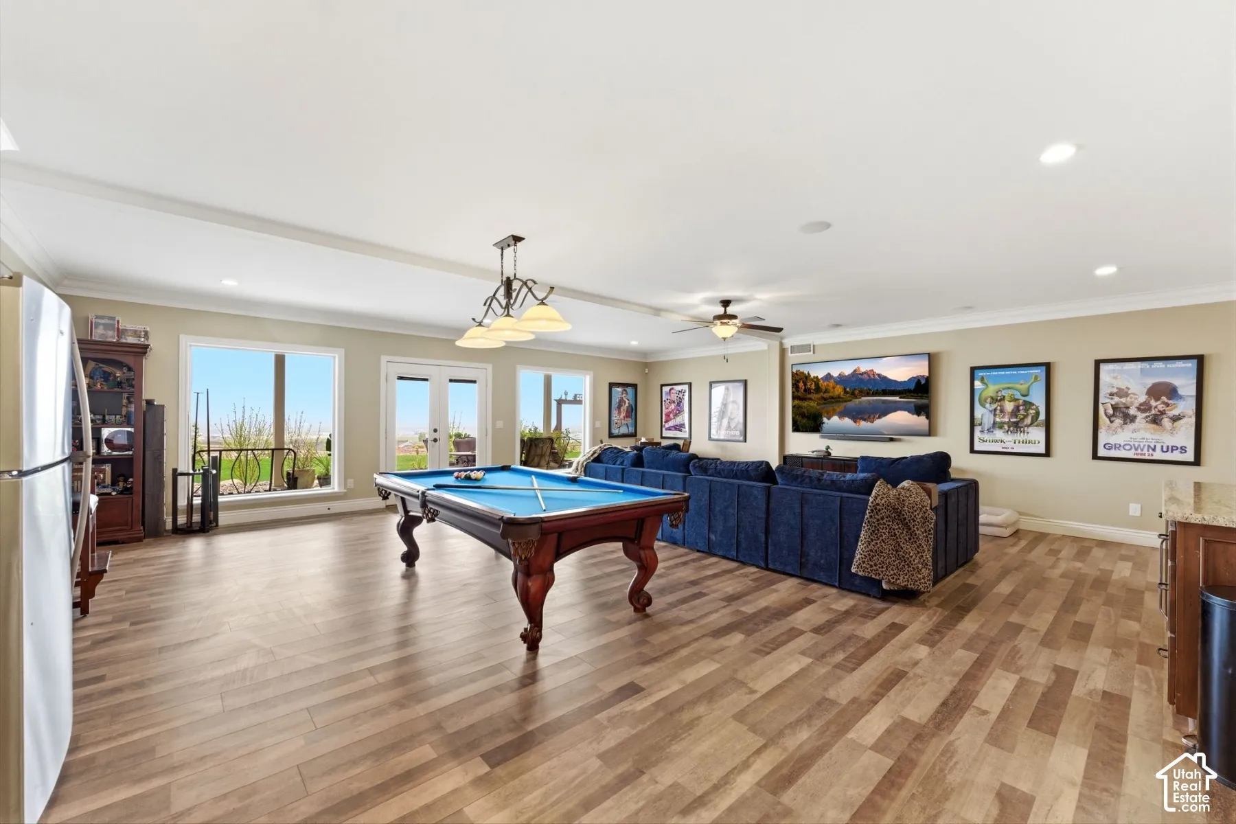 Rec room with french doors, ceiling fan, billiards, light wood finished floors, and ornamental molding