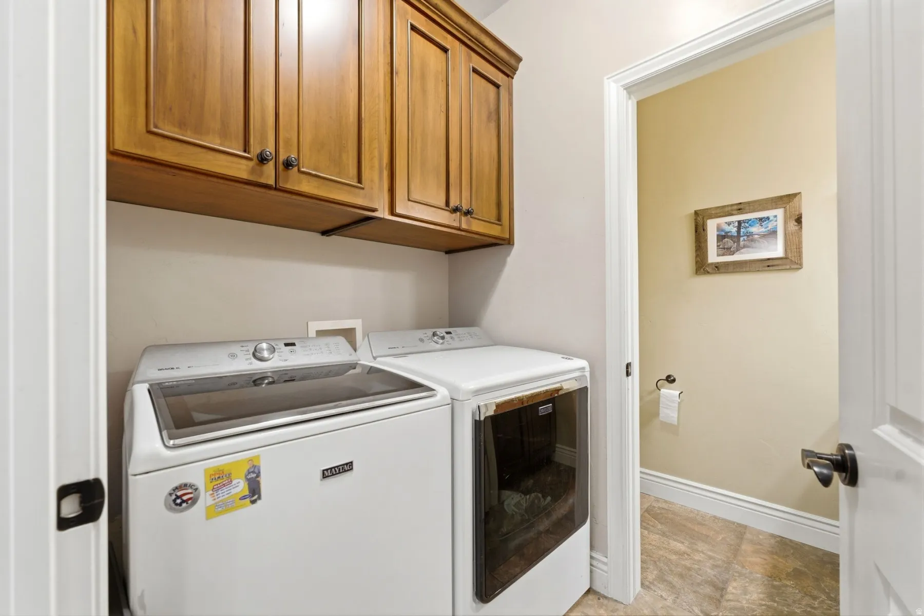 Laundry area featuring cabinet space and washer and clothes dryer