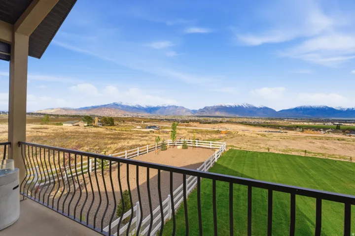Balcony featuring a mountain view and a rural view