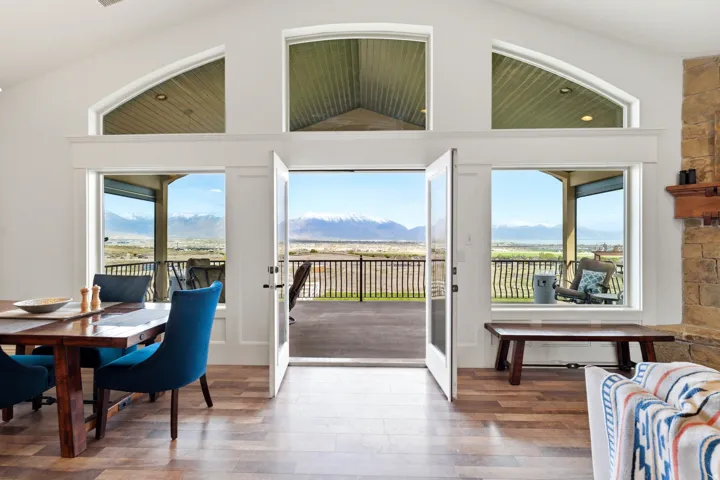 Dining room with a mountain view, plenty of natural light, wood finished floors, and lofted ceiling