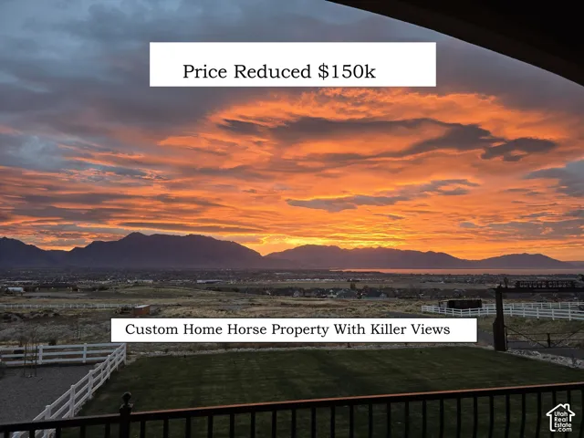 Expansive acreage featuring mountain range and valley scenery, manicured turf, post-and-rail fencing, and an arched metal gateway