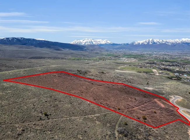 View of rural area featuring a mountain backdrop and property boundaries highlighted