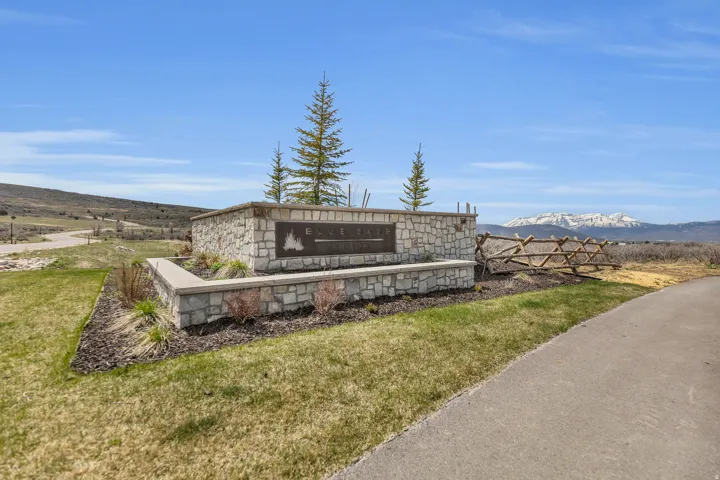 Community sign with a mountain view