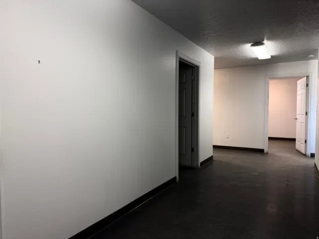 Spare room featuring a textured ceiling and finished concrete flooring