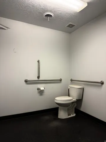 Bathroom with toilet and a textured ceiling