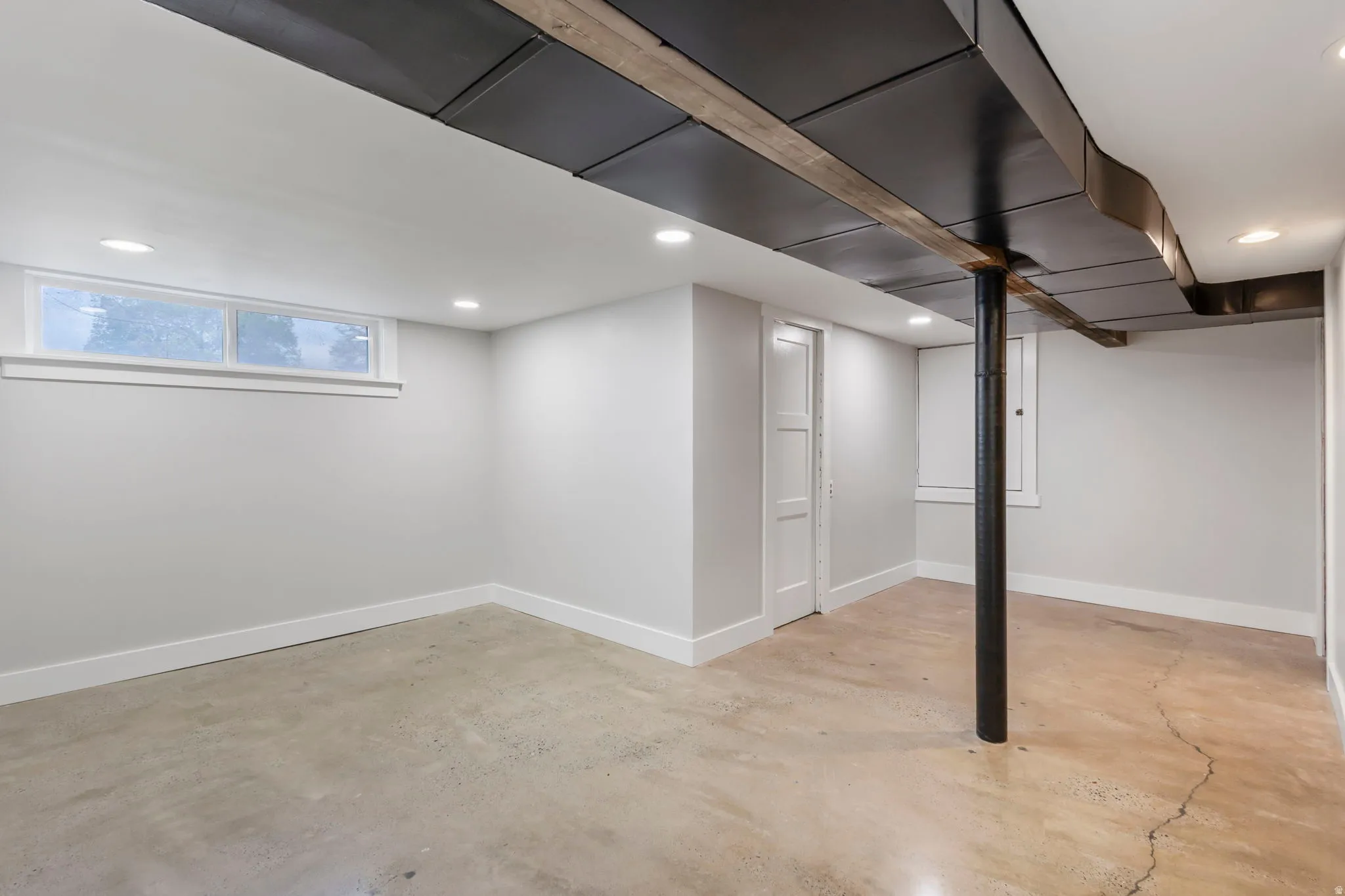 Below grade area with recessed lighting and baseboards