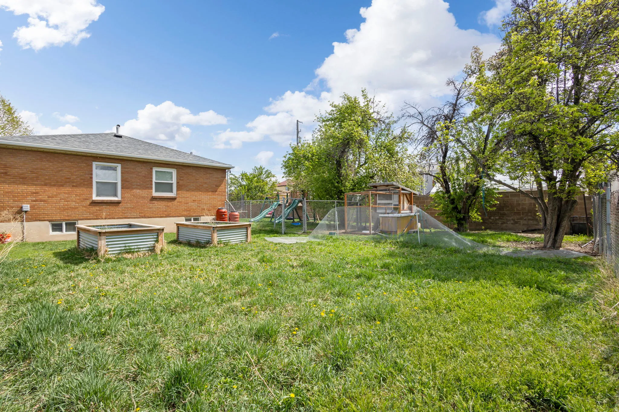 Fenced backyard with a vegetable garden
