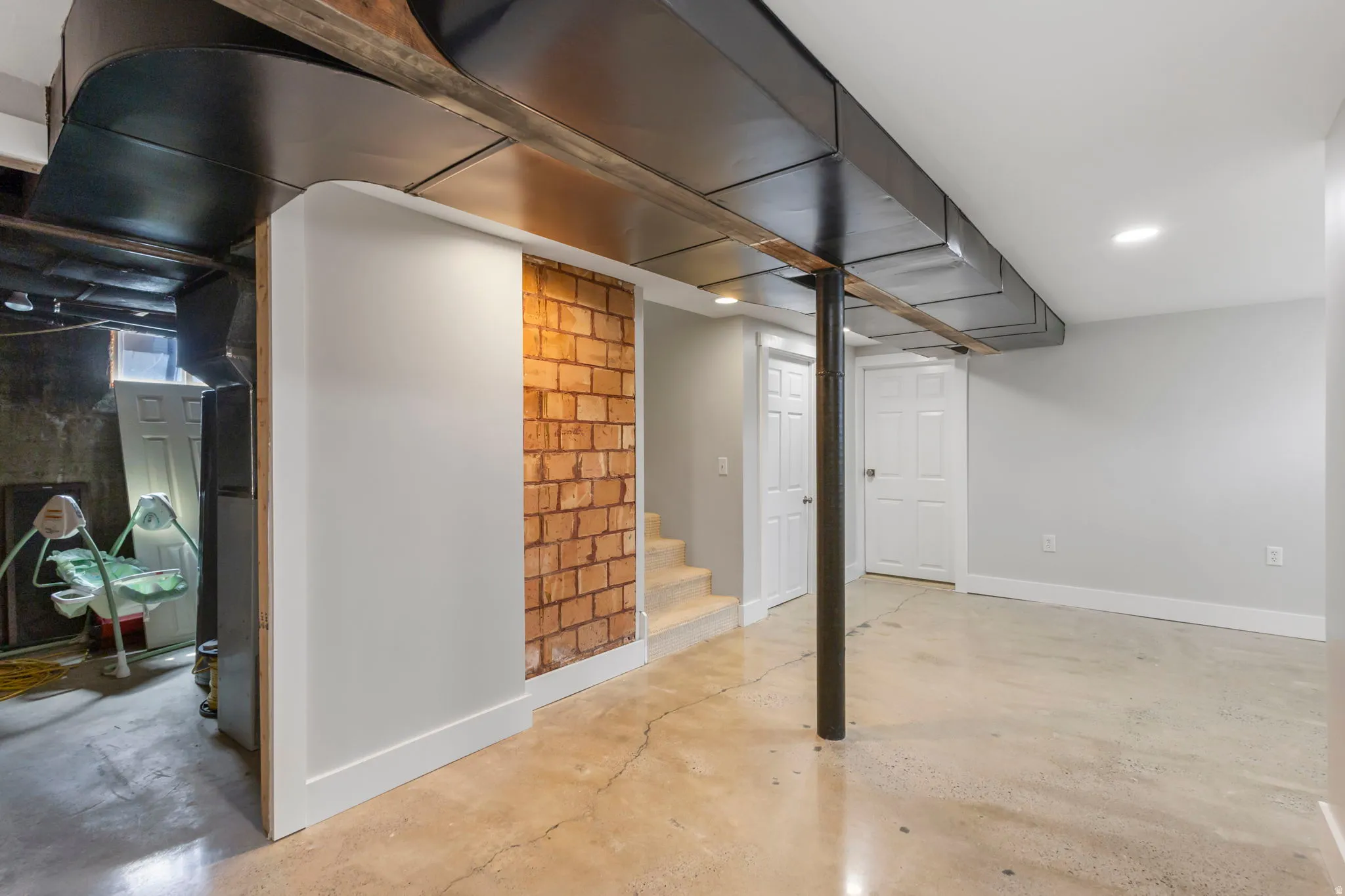 Finished basement with baseboards and recessed lighting