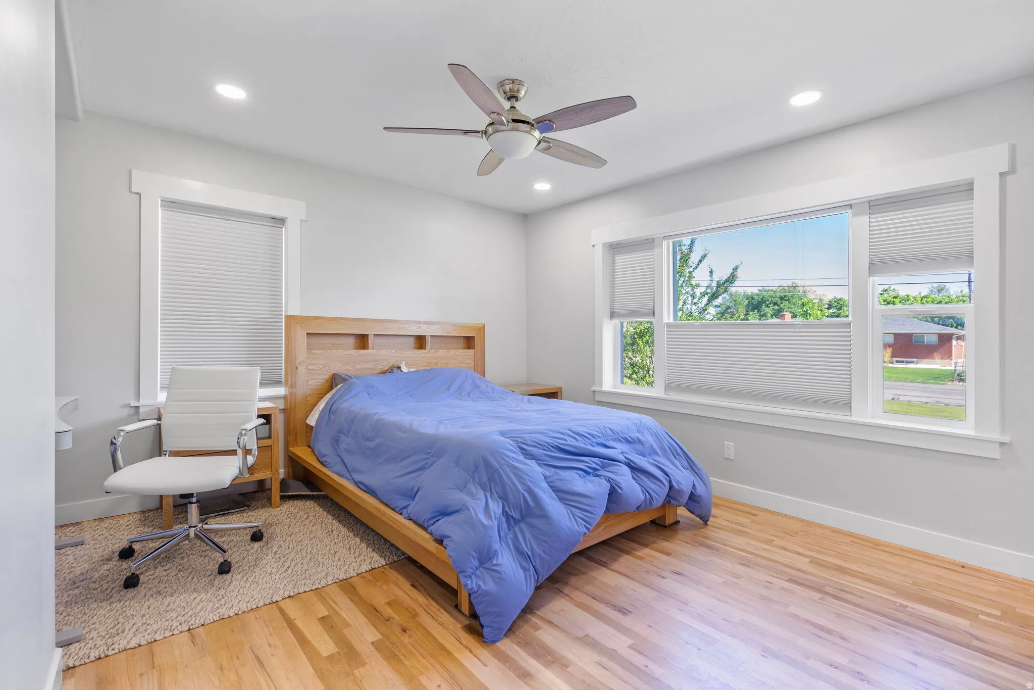 Bedroom with light wood finished floors, a ceiling fan, and recessed lighting