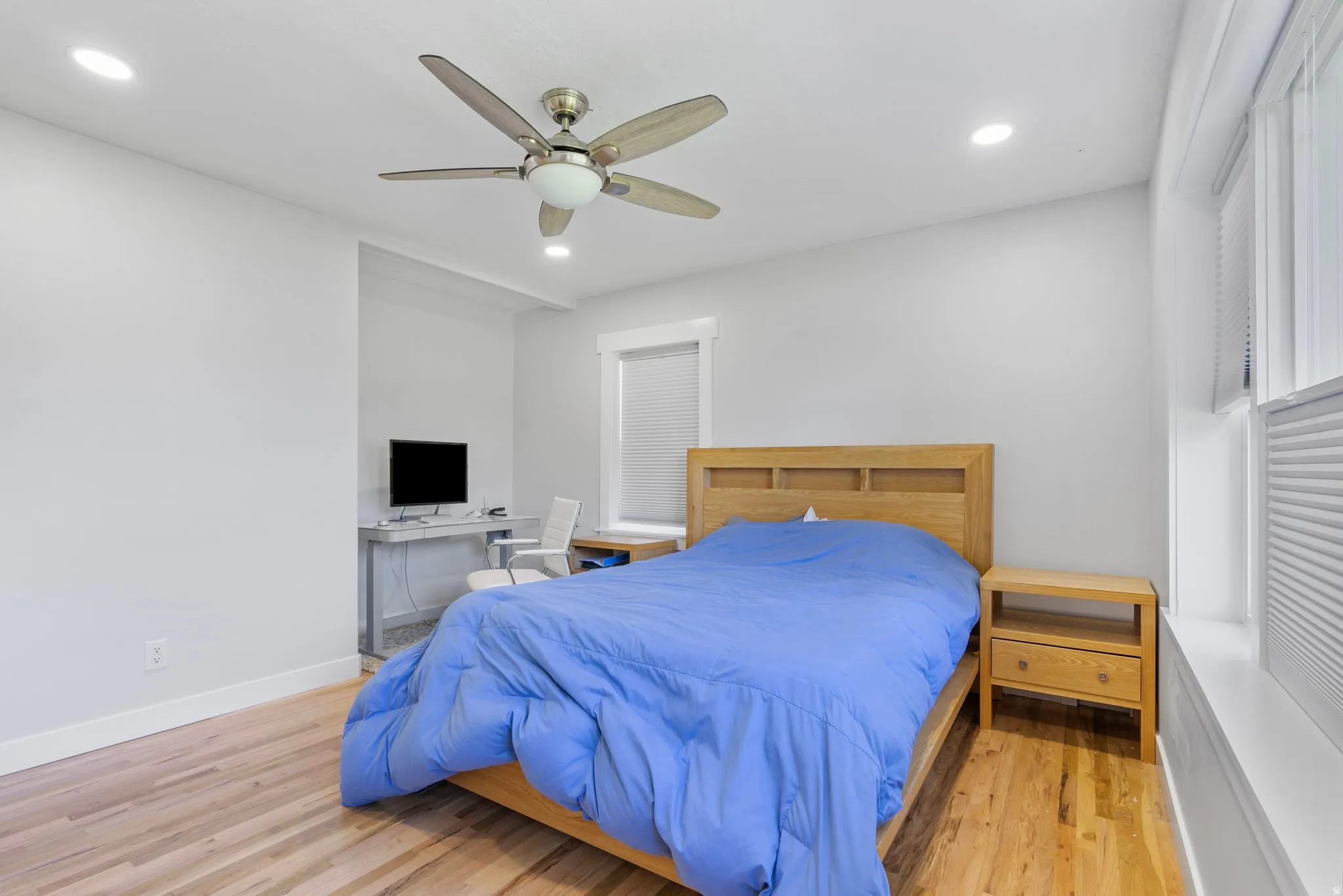 Bedroom with light wood-type flooring, recessed lighting, a ceiling fan, and an office area