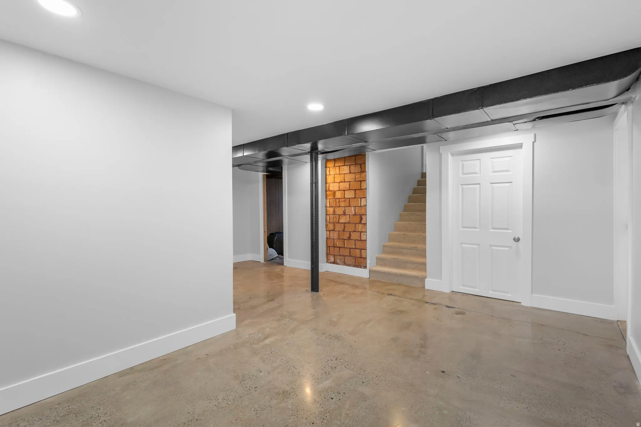 Finished below grade area with stairs and recessed lighting