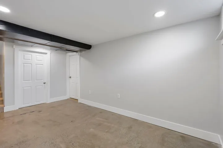 Finished basement featuring baseboards and recessed lighting
