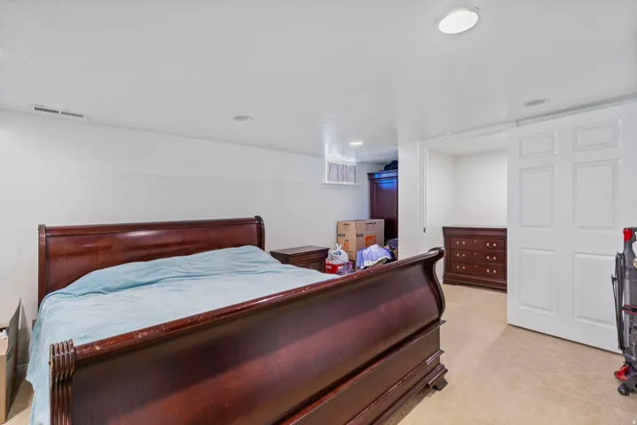Bedroom featuring light carpet