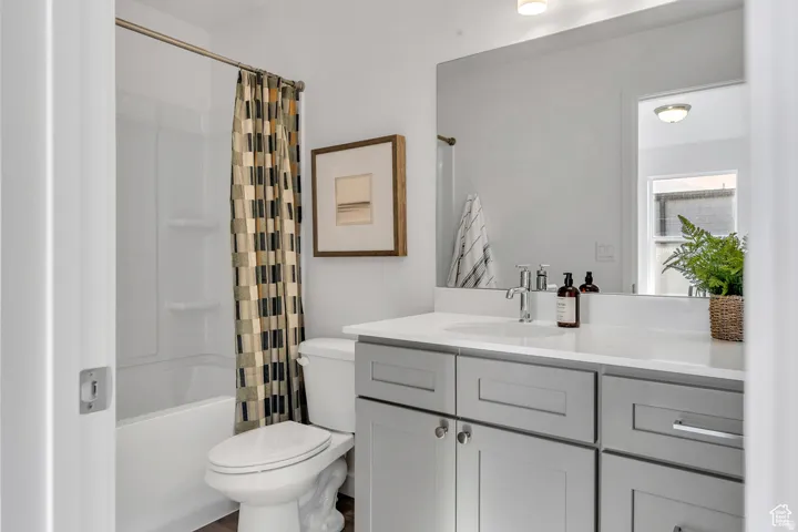 2nd Bathroom featuring vanity and shower / tub combo with curtain