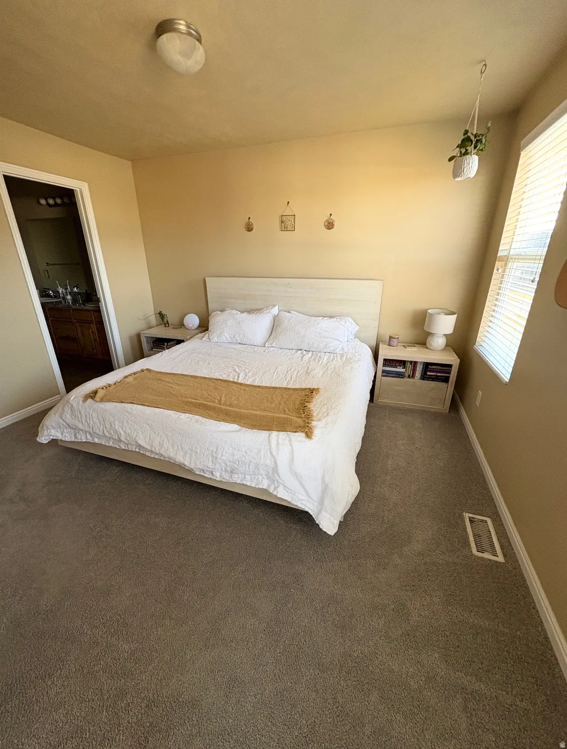Bedroom with dark colored carpet and ensuite bath