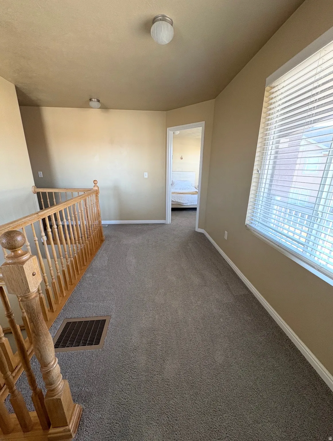 Hallway featuring carpet floors and baseboards