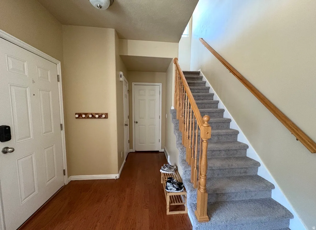 Stairway with wood finished floors and baseboards