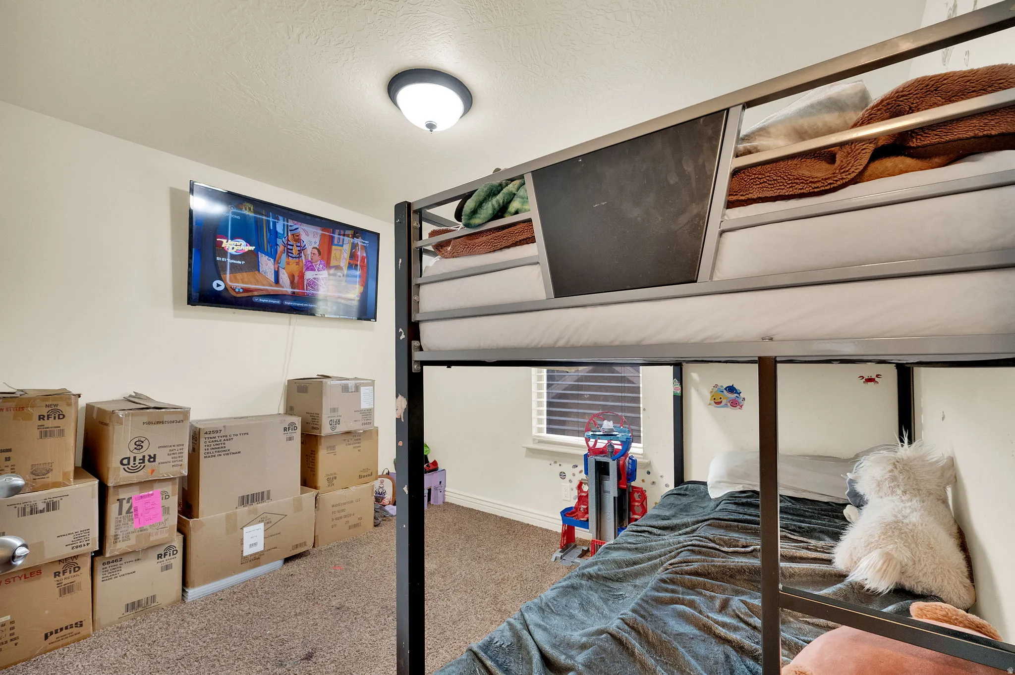 Bedroom featuring carpet flooring and a textured ceiling