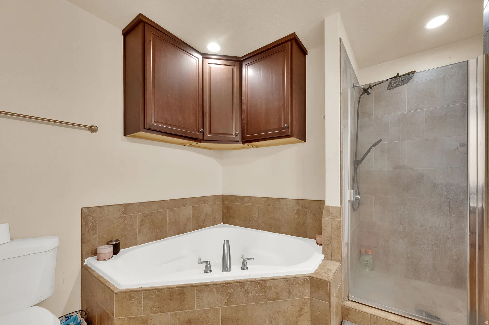Bathroom with a stall shower, a bath, and recessed lighting