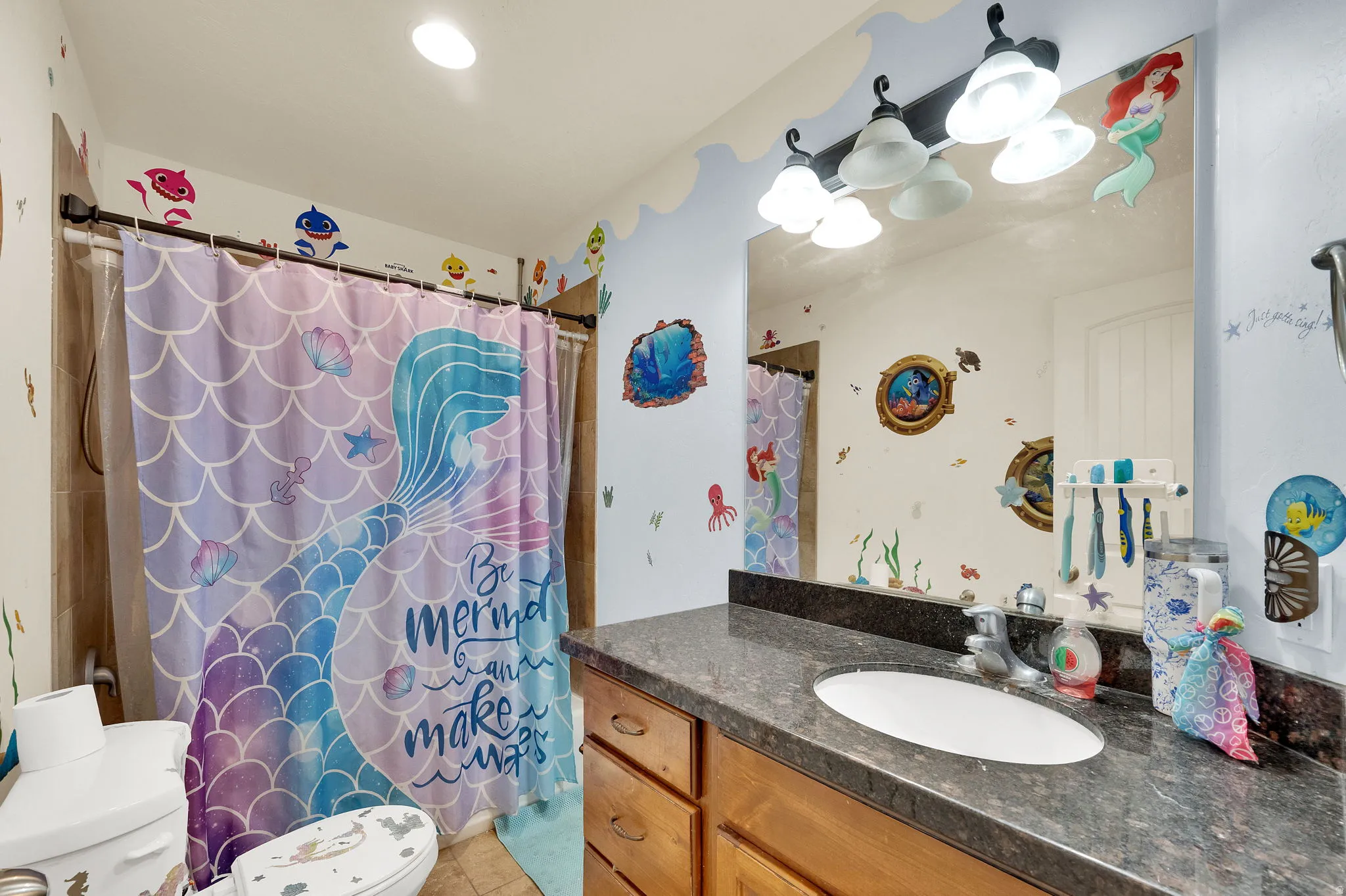 Full bath with vanity, a shower with curtain, and light tile patterned floors