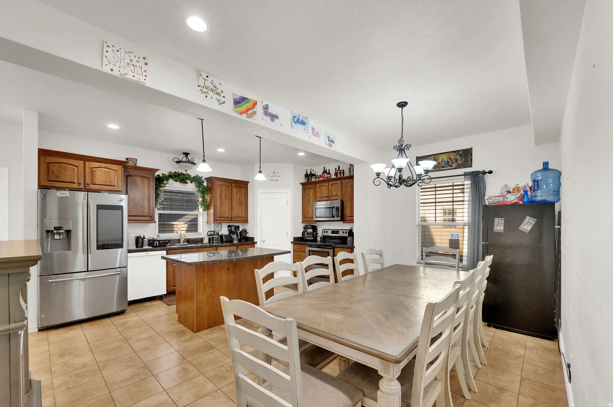 Dining room with light tile patterned flooring and suspended lighting