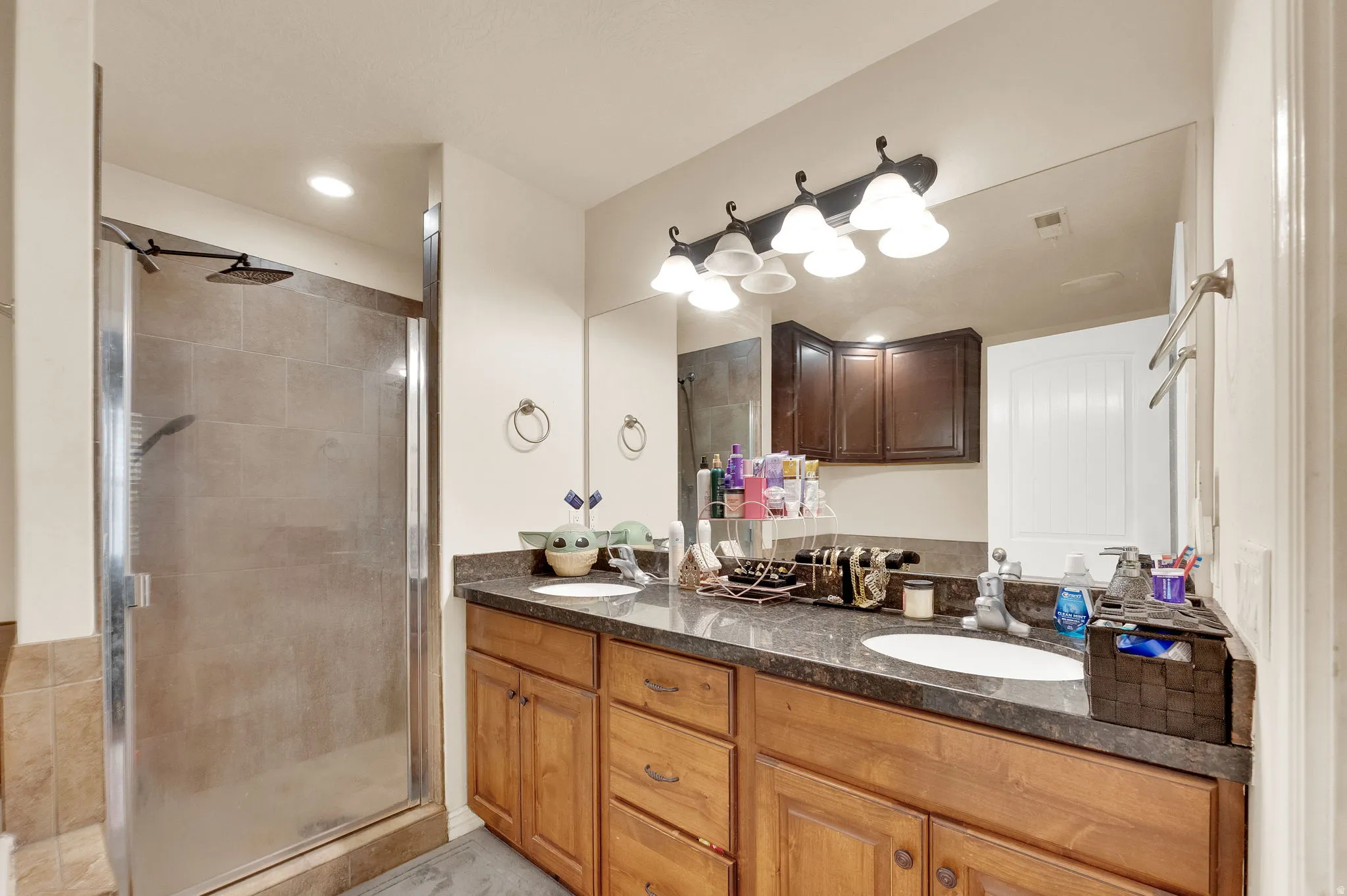 Bathroom with double vanity and a stall shower