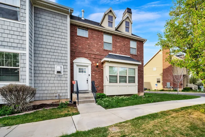View of front facade featuring a front lawn and brick siding