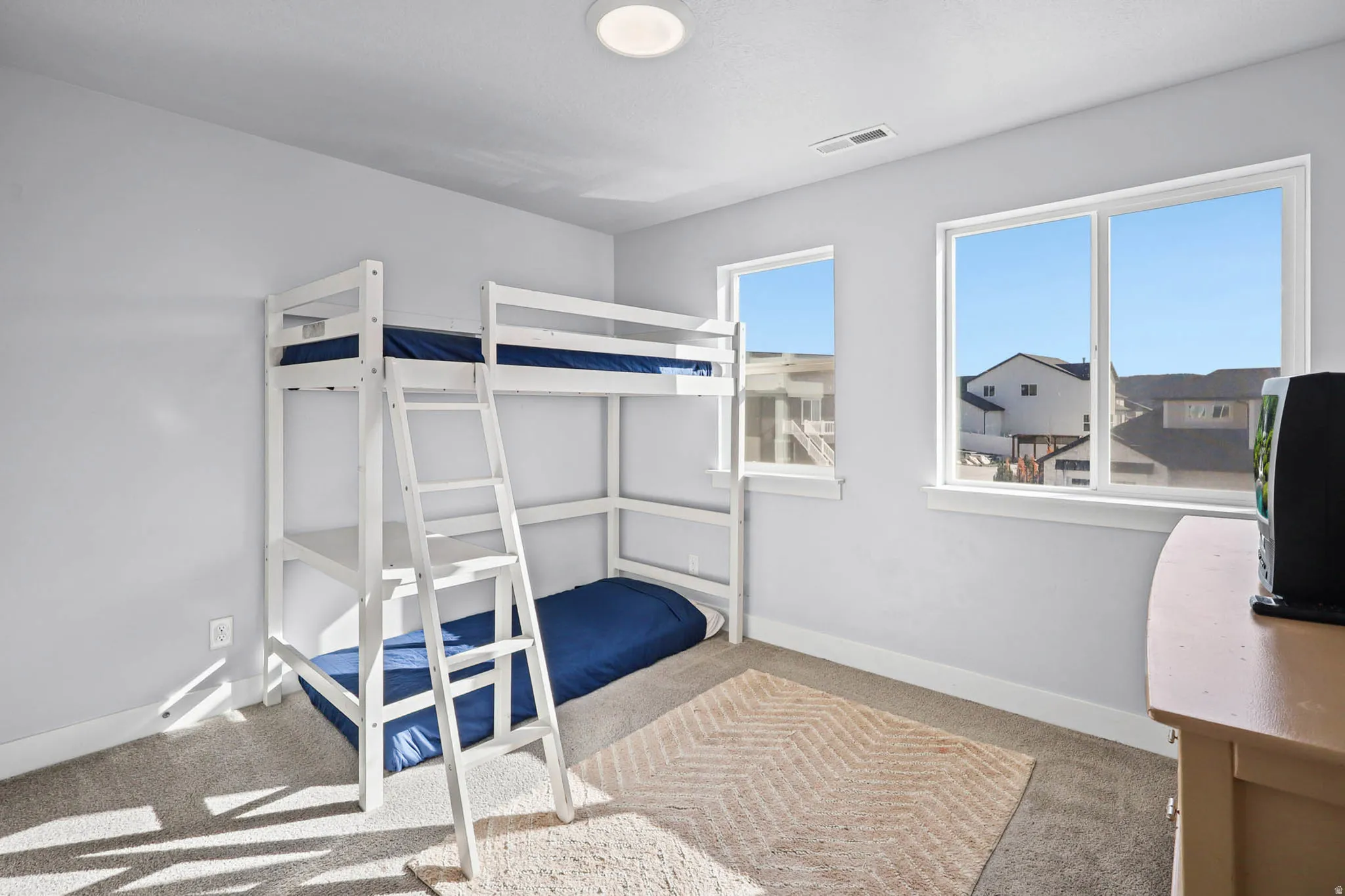 Bedroom featuring light colored carpet and baseboards