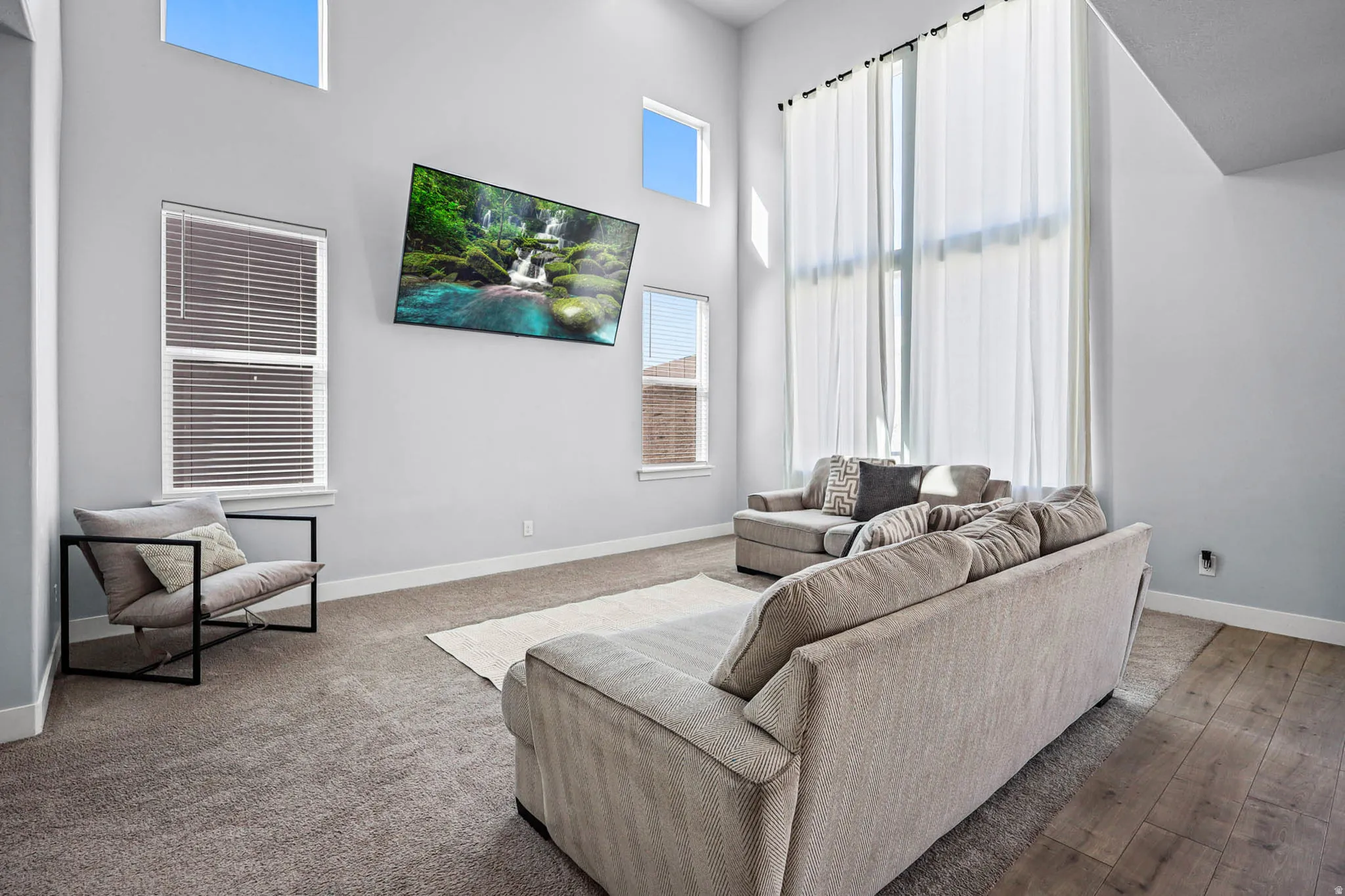 Living room with a high ceiling and baseboards