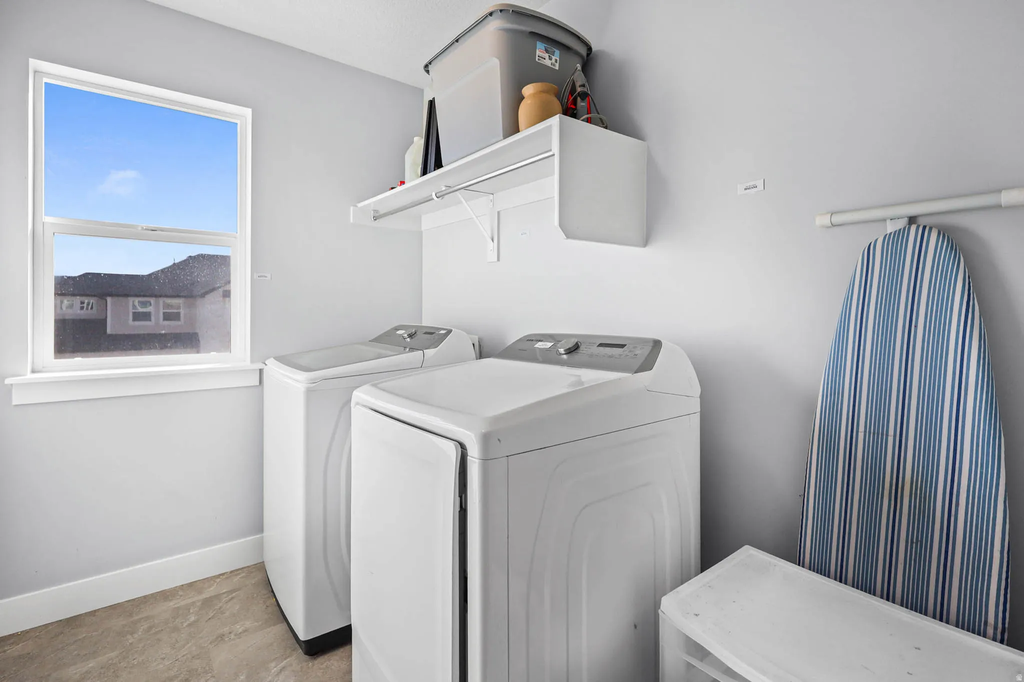 Laundry area upstairs featuring washer and dryer and baseboards