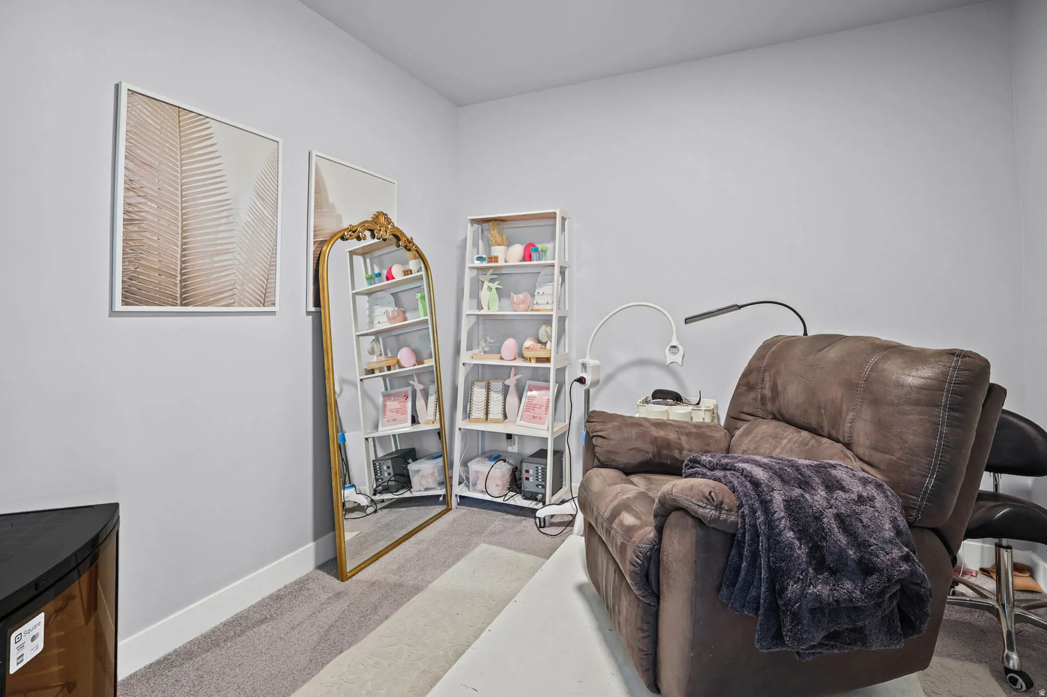 Office/den with light colored carpet and baseboards
