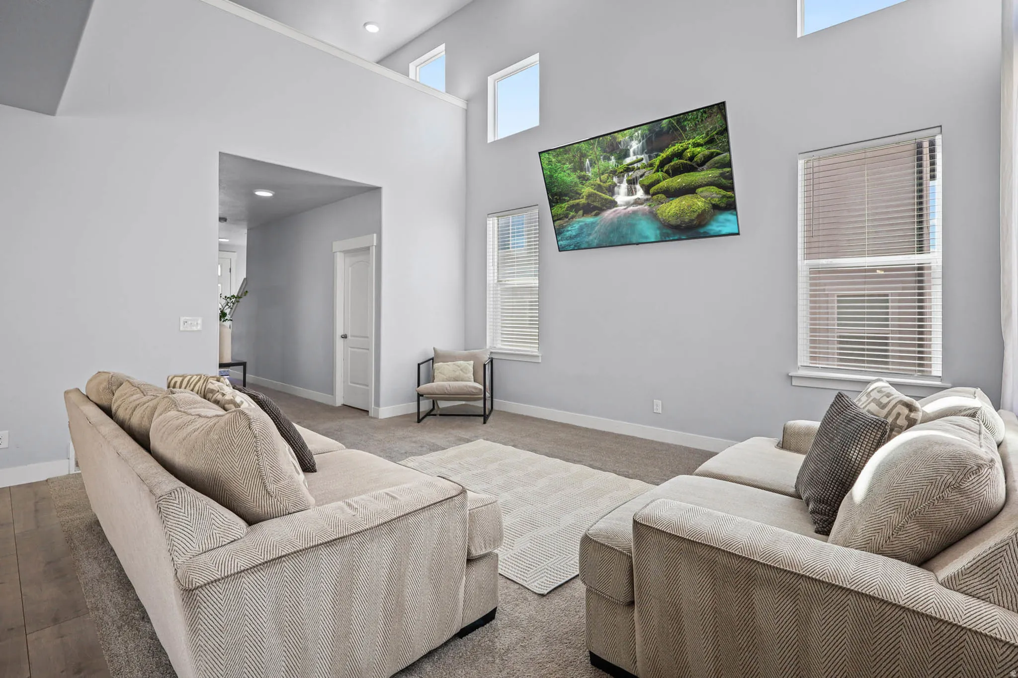 Living area with a high ceiling and baseboards