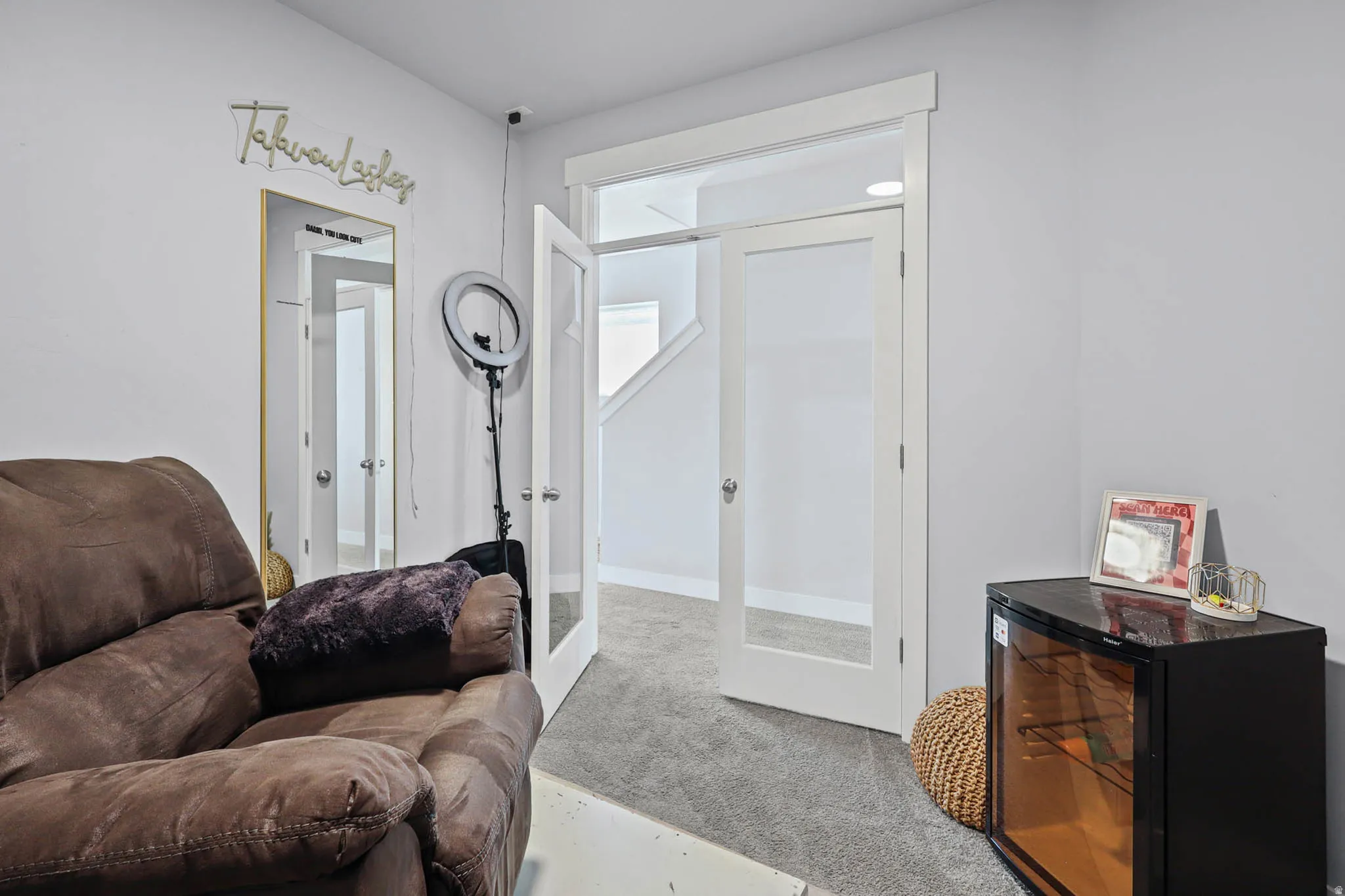 Carpeted office/den with french doors