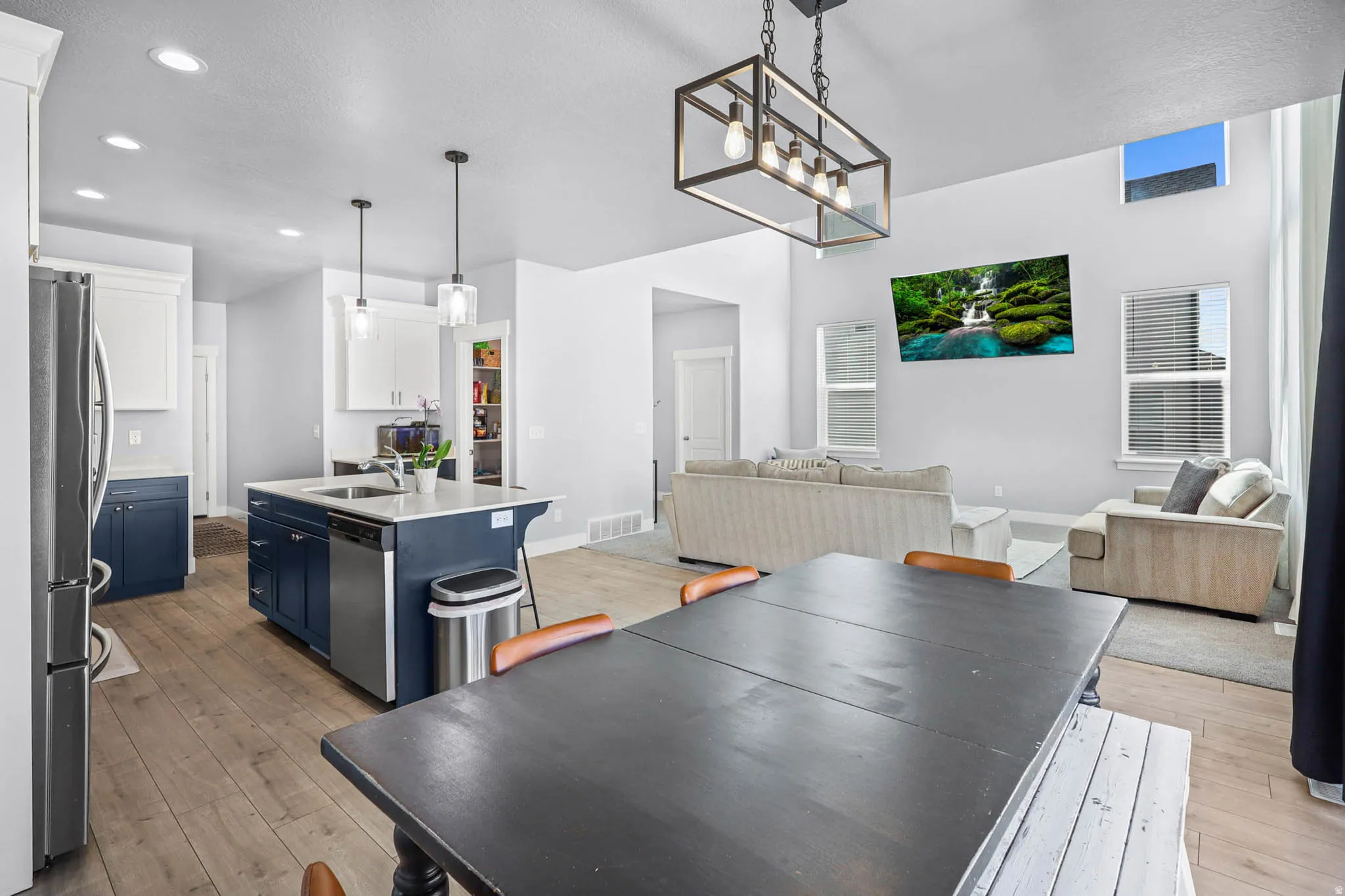 Dining area with light wood-style floors, a textured ceiling, and a chandelier