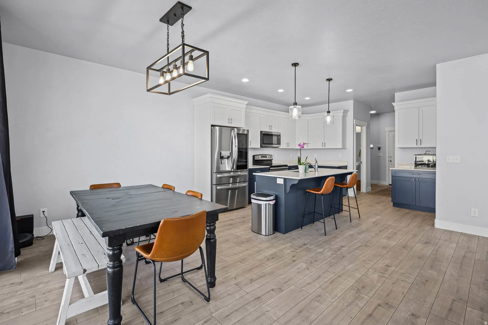 Dining room featuring light wood-style floors and hanging lights
