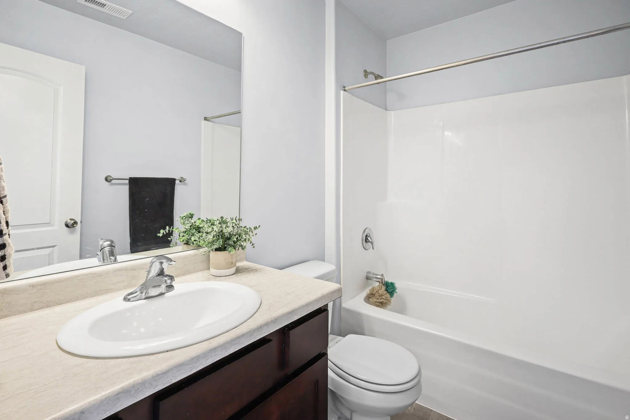 Full bathroom featuring vanity and washtub / shower combination
