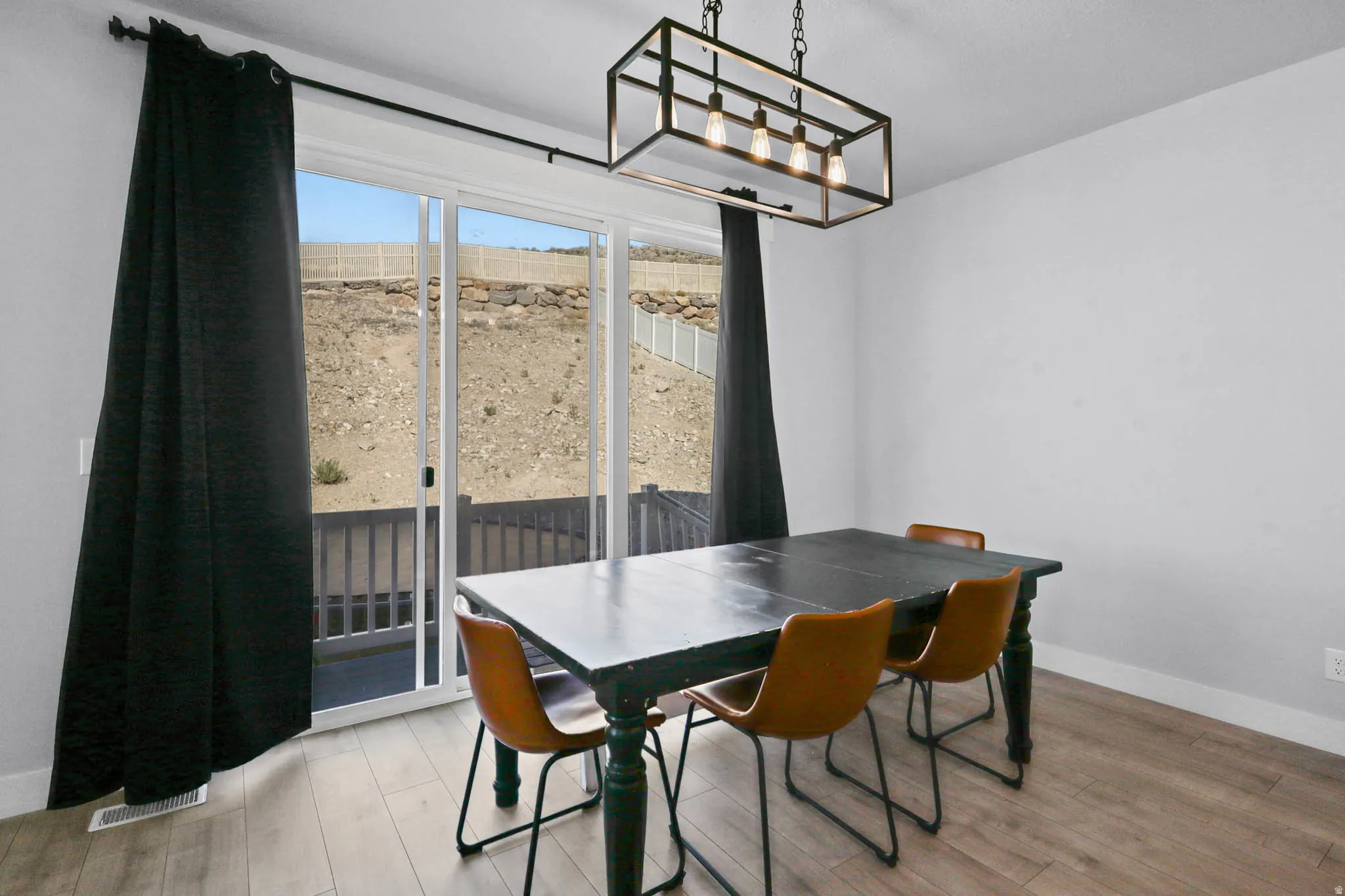 Dining room with light wood-style flooring and a chandelier