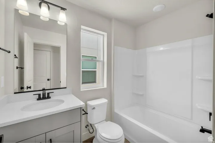 Bathroom featuring vanity and  shower combination