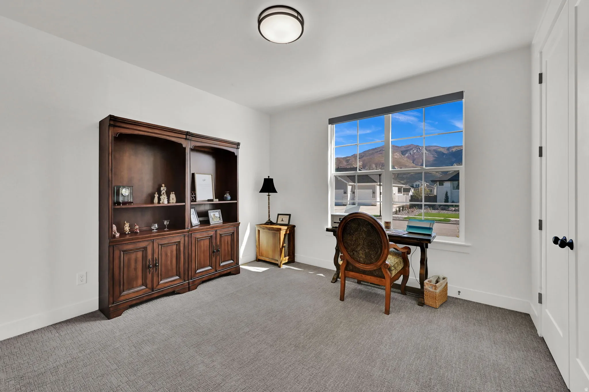 Office featuring a mountain view and light carpet