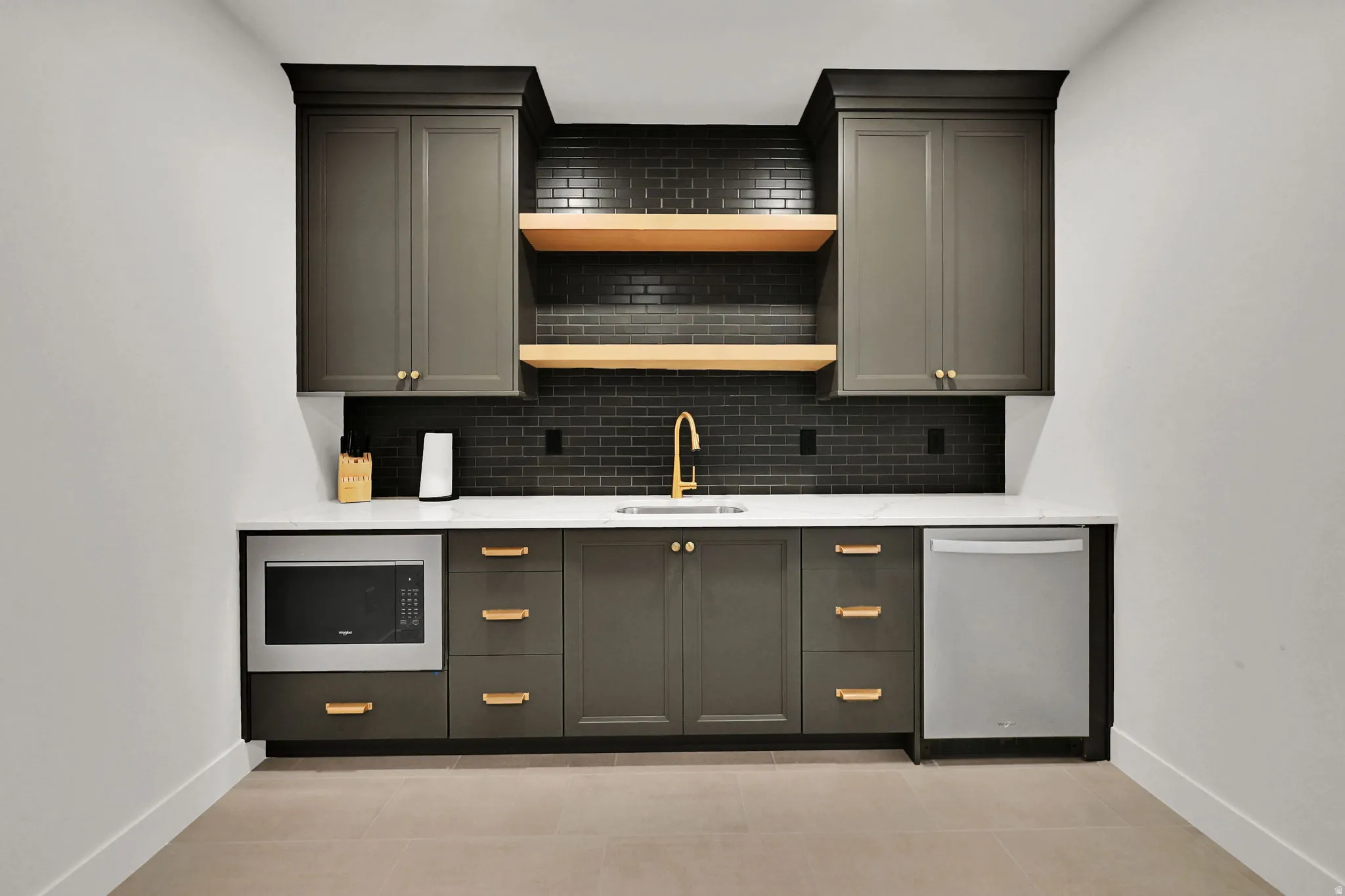 Bar featuring decorative backsplash, stainless steel appliances, light stone countertops, and open shelves
